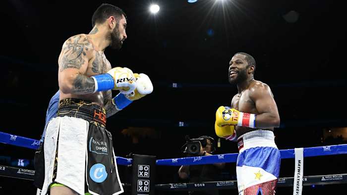 Floyd Mayweather and John Gotti III in the middle of their boxing exhibition match at the FLA Live Arena in Sunrise, Florida.